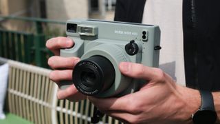 Fujifilm Instax Wide 400 camera held in a person's hands