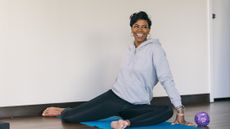 Woman doing 90/90 hip mobility stretch on a yoga mat
