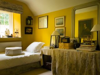 bedroom with yellow walls and white bedlinen