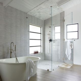 bathroom with wooden flooring and white washbasin
