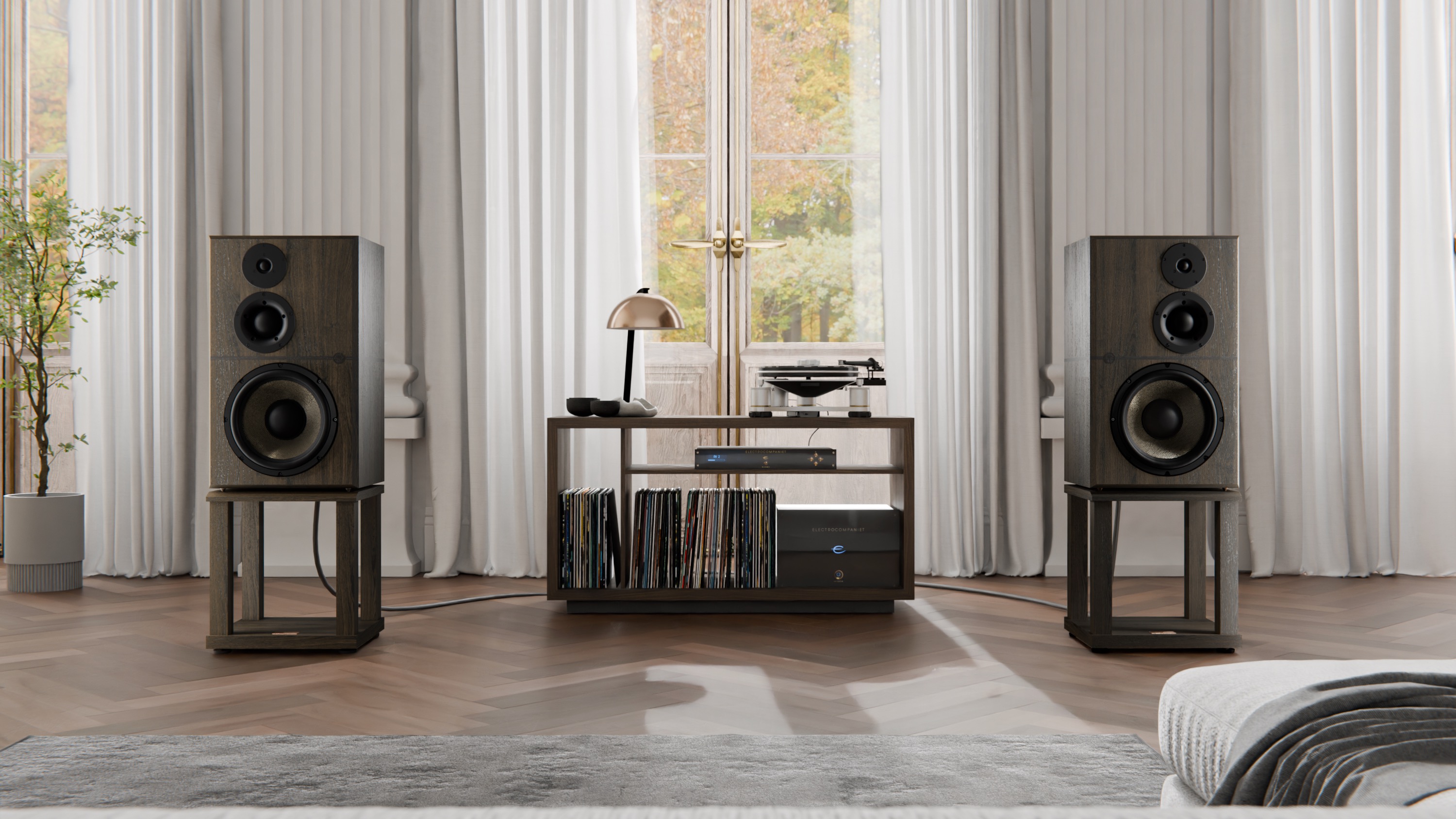 A pair of Revival Audio Atalanta Grande R&amp;eacute;serve speakers on stands either side of a furniture unit, shot straight on.