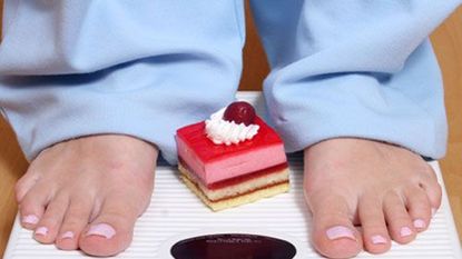 feet on scale with cake between feet