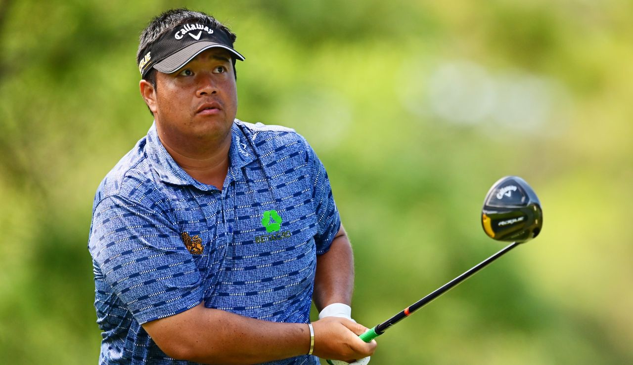 Aphibarnrat watches his tee shot whilst holding his driver