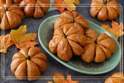 A plate of bread buns in the shape of pumpkins