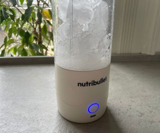 The Nutribullet Portable Blender filled with uncrushed ice cubes