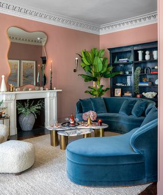 Pink living room with blue sofa and alcove shelving