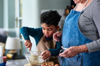 Child baking with grandma