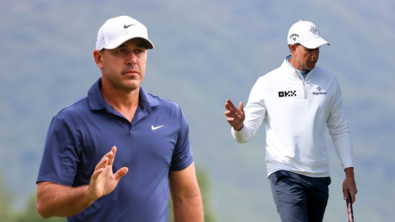Brooks Koepka (left) and Henrik Stenson wave to the crowd