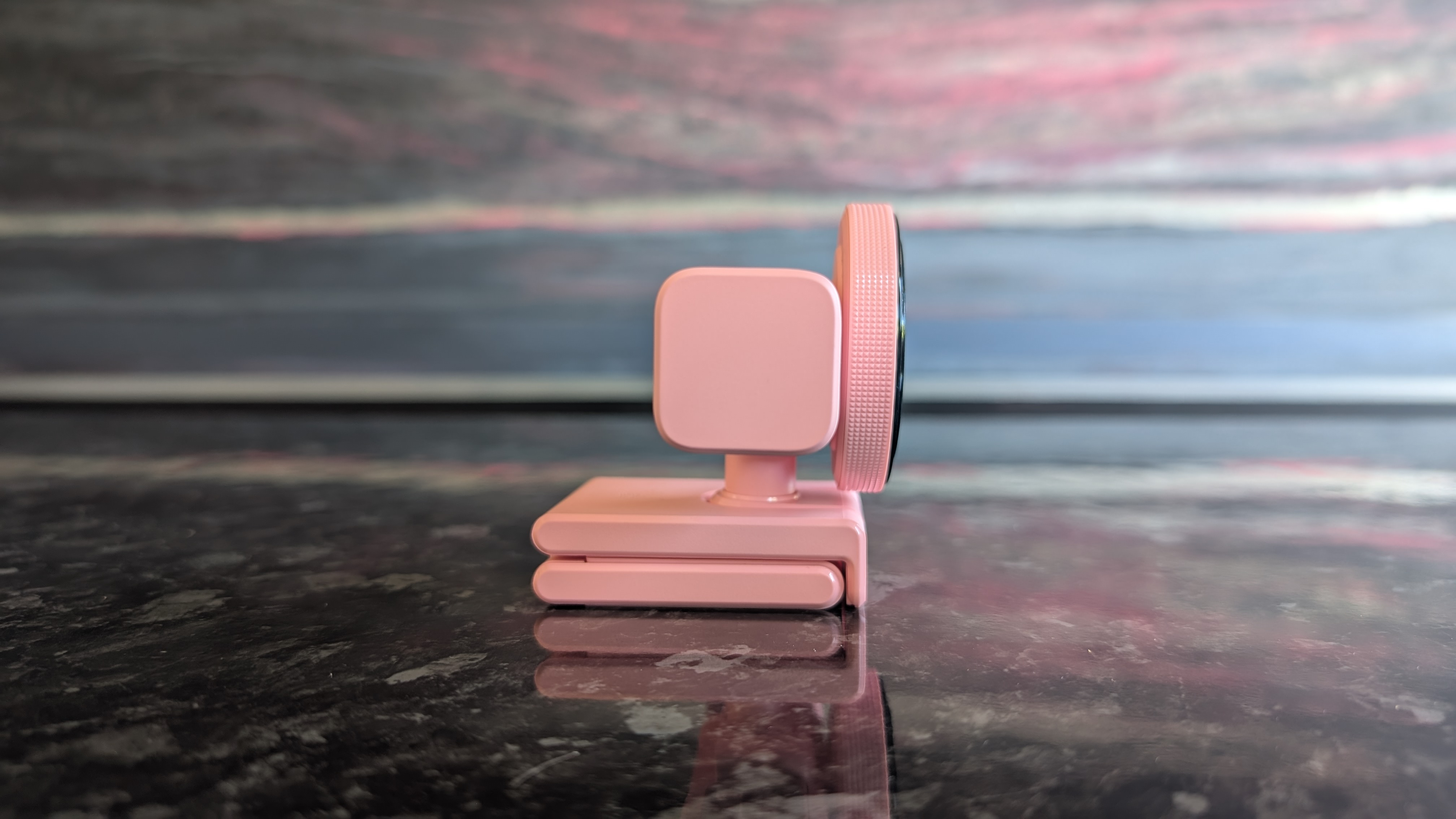 The Razer Kiyo V2 webcam pictured on a dark marble worksurface.