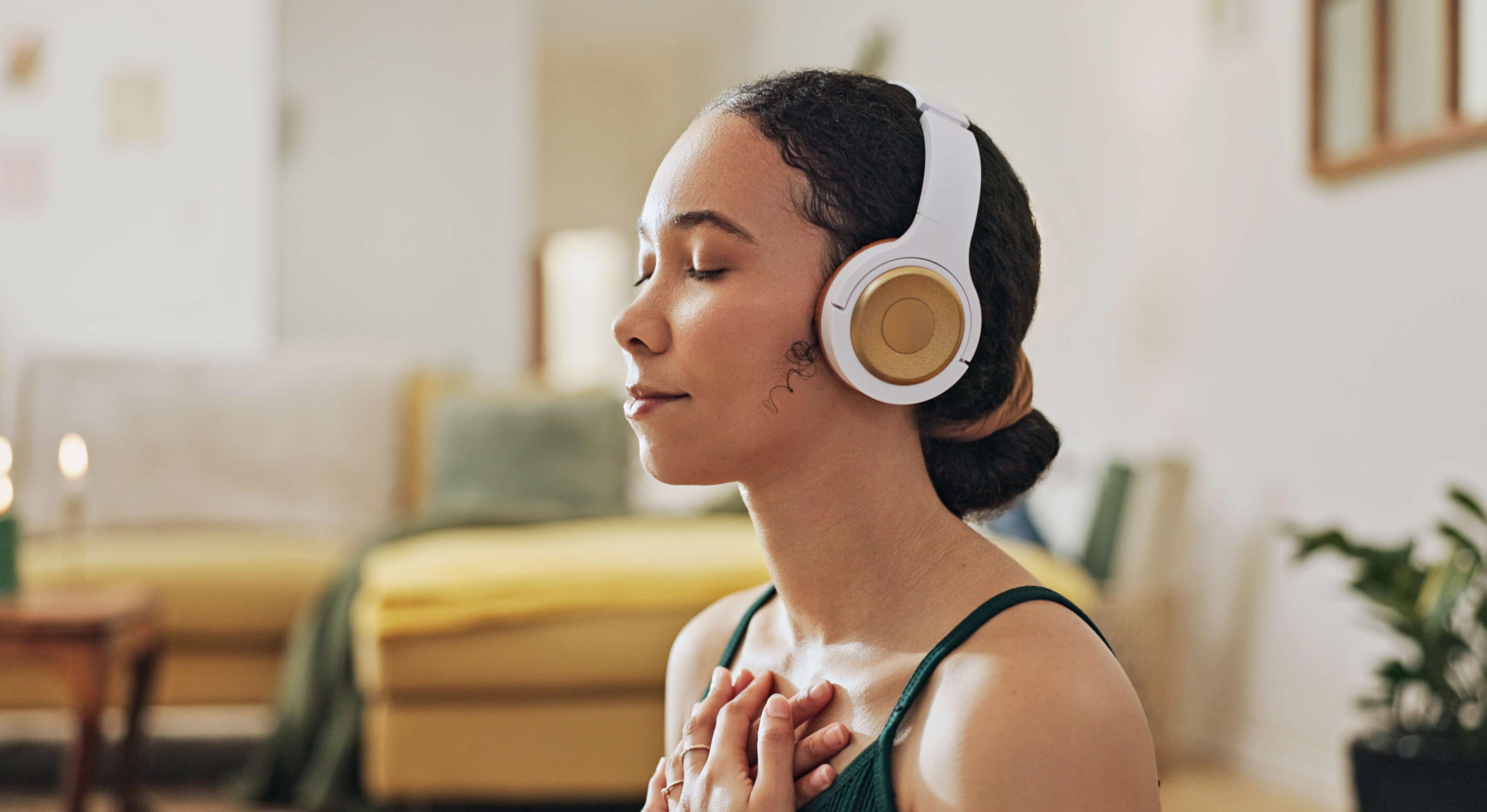  Woman, meditation and yoga in headphones listening to calm music, holistic exercise and peace in living room. 