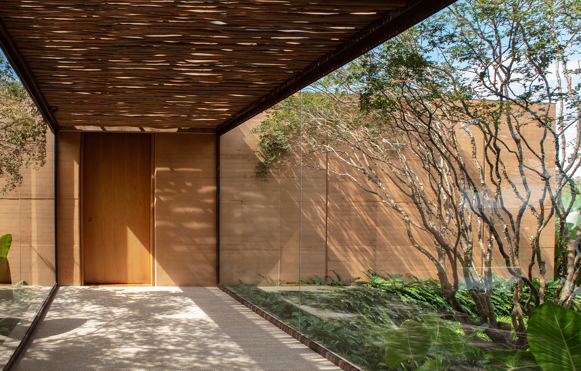 A glazed walkway links the two wings of the house