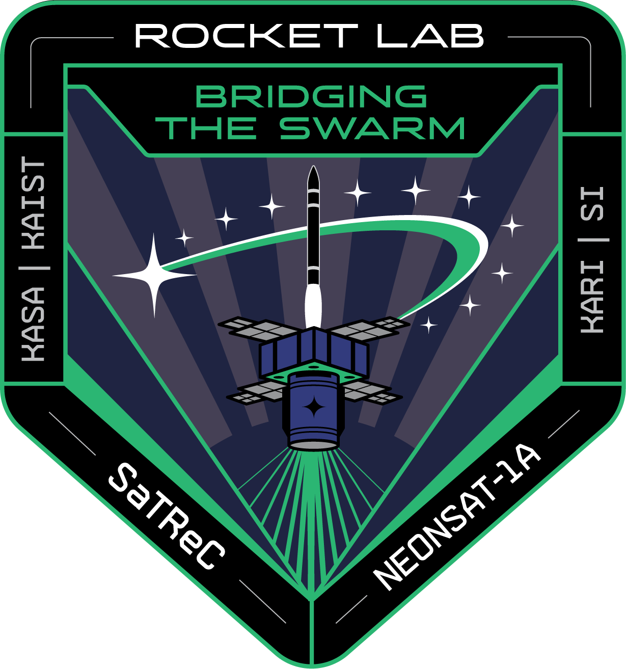 A black mission patch with pale lime green colors is shaped like the home plate on a baseball field.