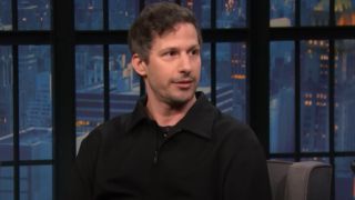 Andy Samberg on Late Night with Seth Meyers looking to his right. 