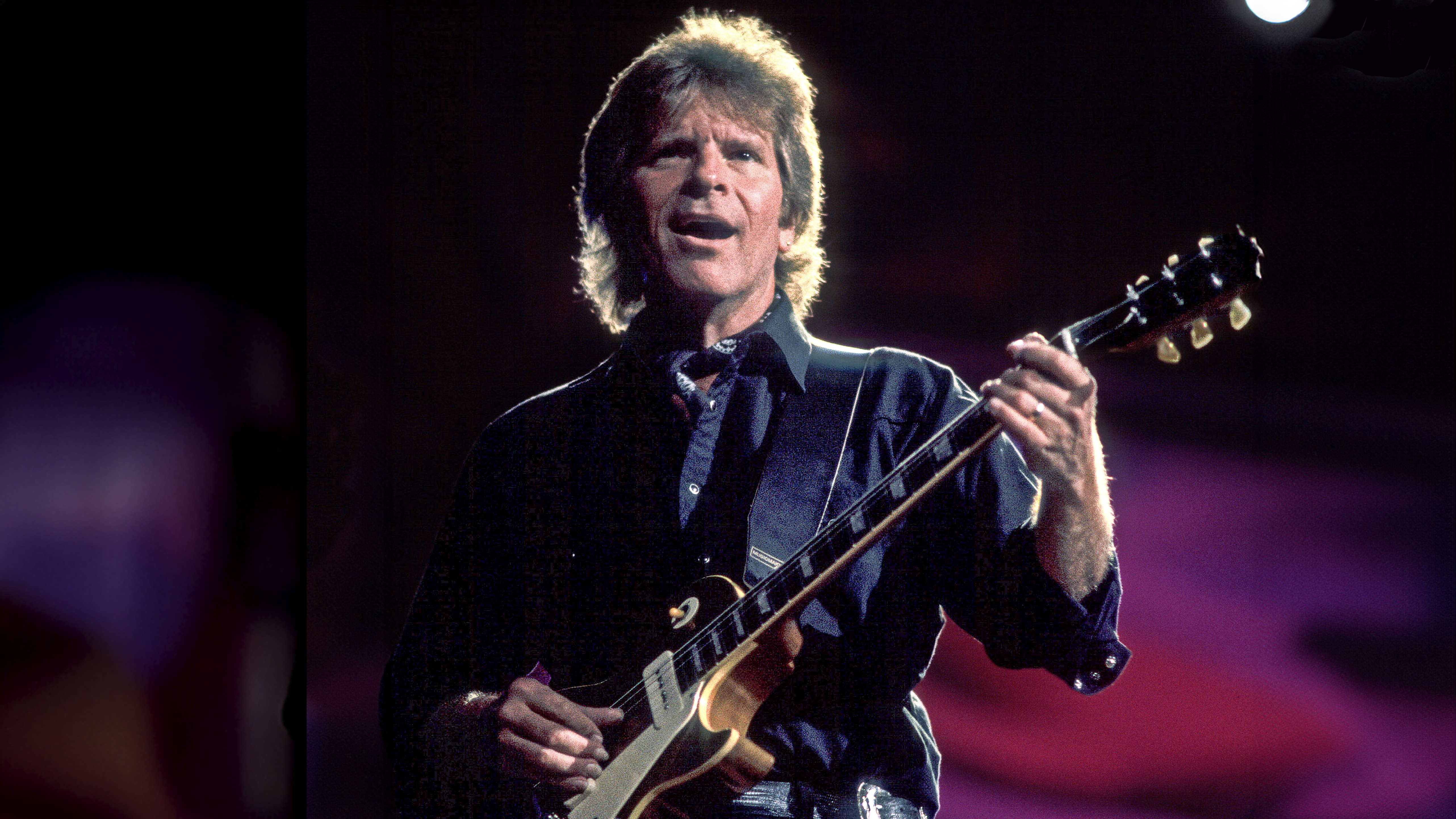 American Rock musician John Fogerty plays guitar as he performs onstage during the Farm Aid benefit concert at the World Music Theater, Tinley Park, Illinois, October 8, 1997. 