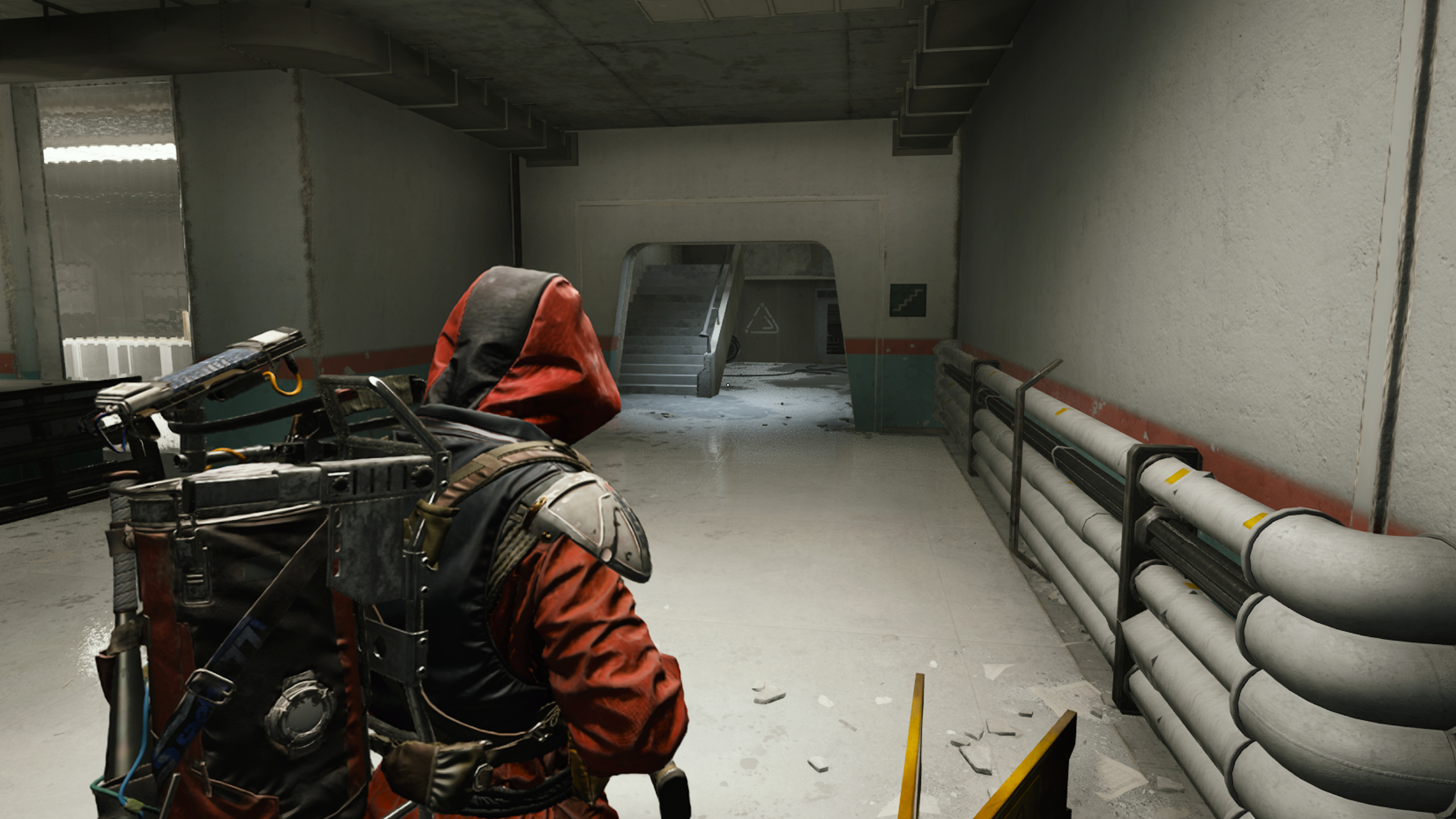 Arc Raiders Furtive Meetings: A player looking at a staircase in Medical Research with white graffiti on the wall in the distance.
