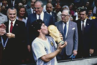Diego Maradona kisses the World Cup trophy after Argentina's win in 1986.