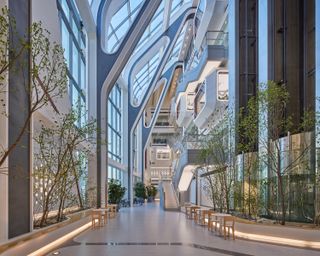 Interior with high ceilings, glazing and planting at YG Entertainment headquarters