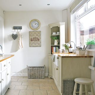 washing up station with freestanding belfast sink unit floor tiles and cabinet