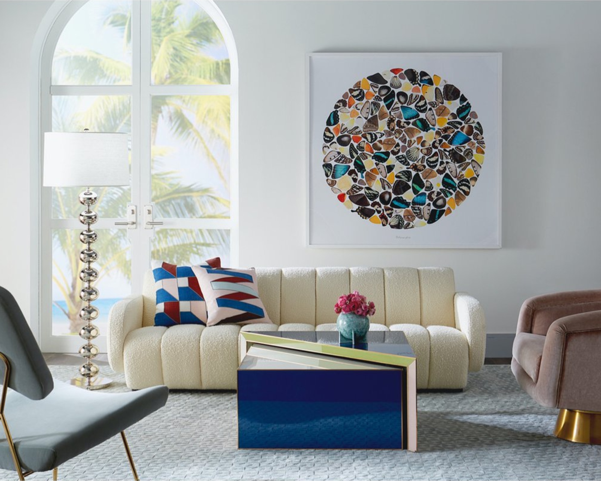 A white boucle fluted couch in a playfully decorated living room