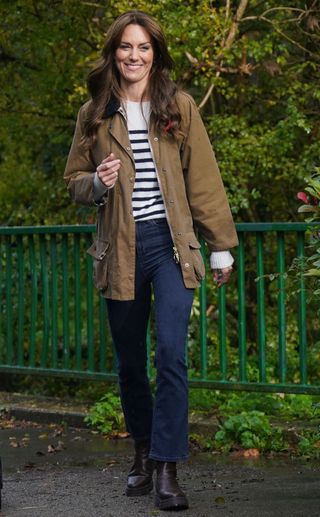 Kate Middleton wears striped Breton sweater and Barbour rain jacket.