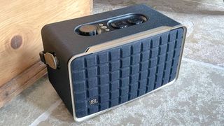 JBL Authentics 300 speaker on floor near a wooden crate
