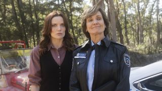 Anna Samson as Detective Inspector Mackenzie Clarke and Catherine McClements as Senior Sergeant Philomena Strong standing next to each other in an episode of Return to Paradise