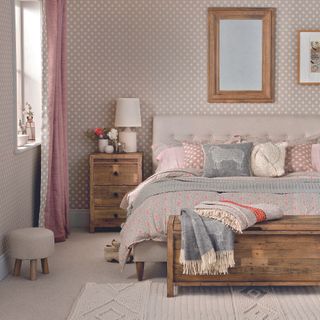 A neutral scheme bedroom with a beige carpet flooring layered with a cream rug