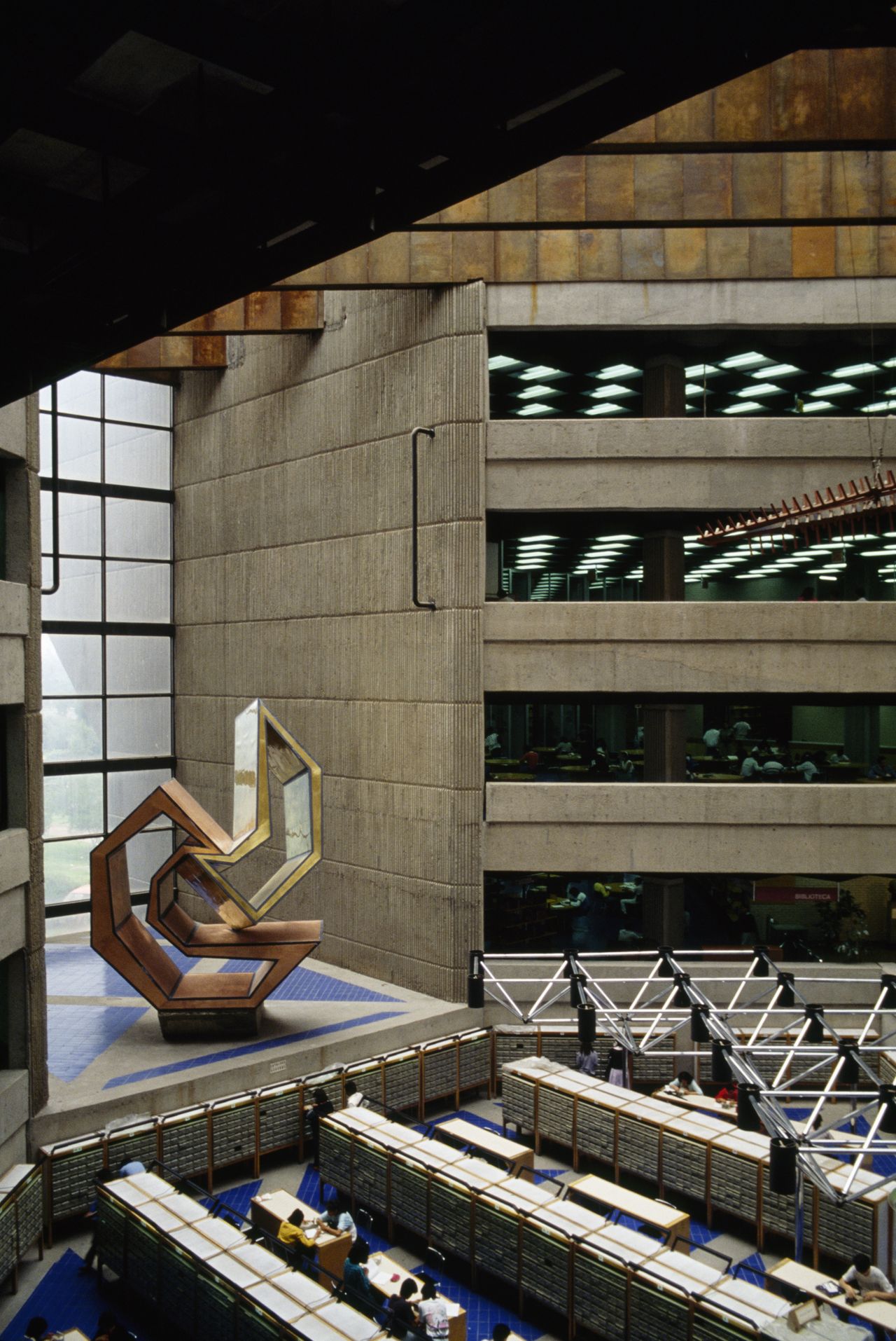 A university library set within a brutalist, modernist building.