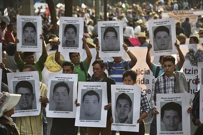 Relatives of the missing Mexican students take part in a protest.