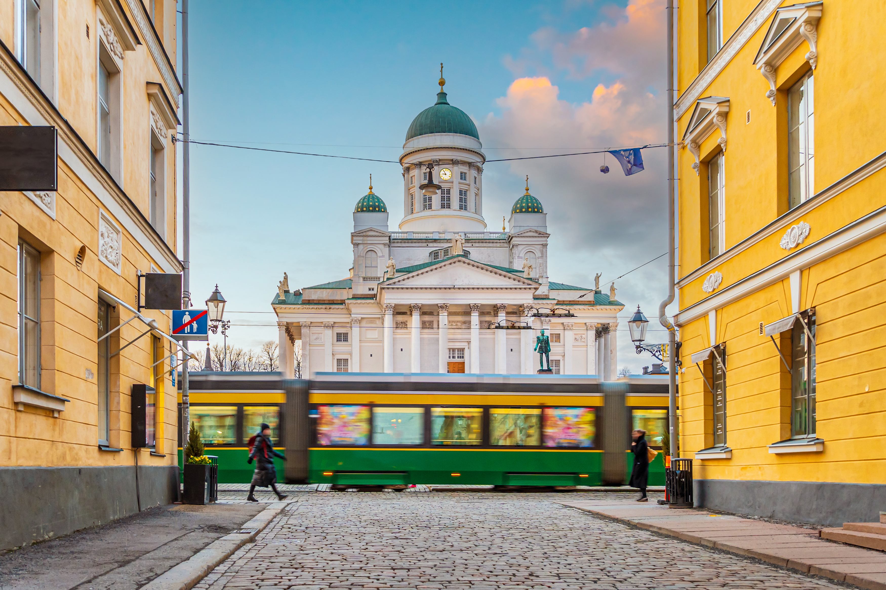 Moving tram and Helsinki Cathedral in the centre of Helsinki, Finland at sunset