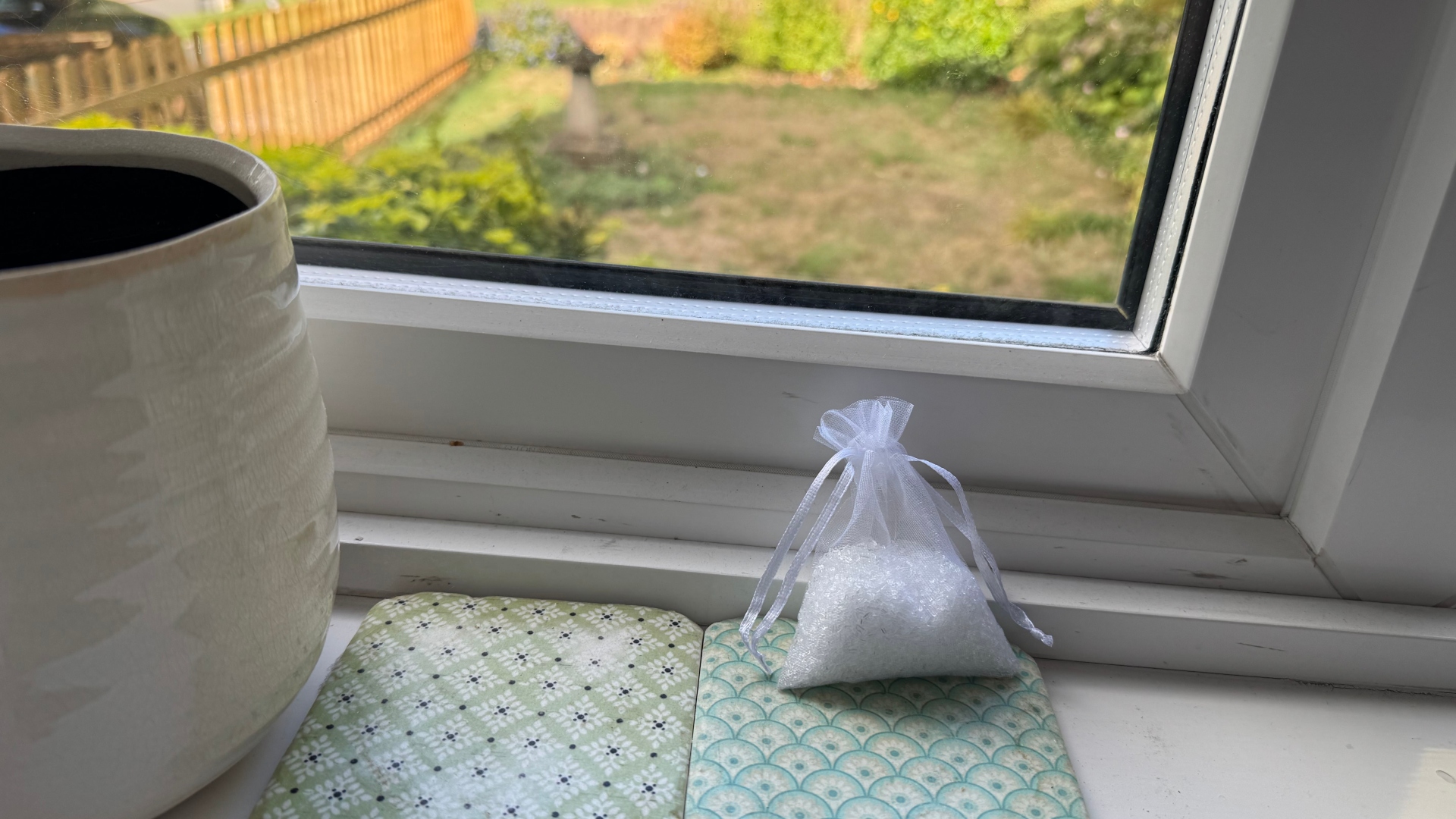 A bag of epsom salt and essential oil is placed on a windowsill to stop spiders coming in