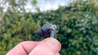 Nothing Ear 2024 buds head in reviewer's finger tips