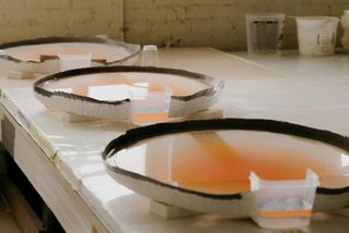 A series of Helen Pashgian's ‘Lenses’ in progress in her Pasadena studio. The moulds have been filled with urethane and left to dry