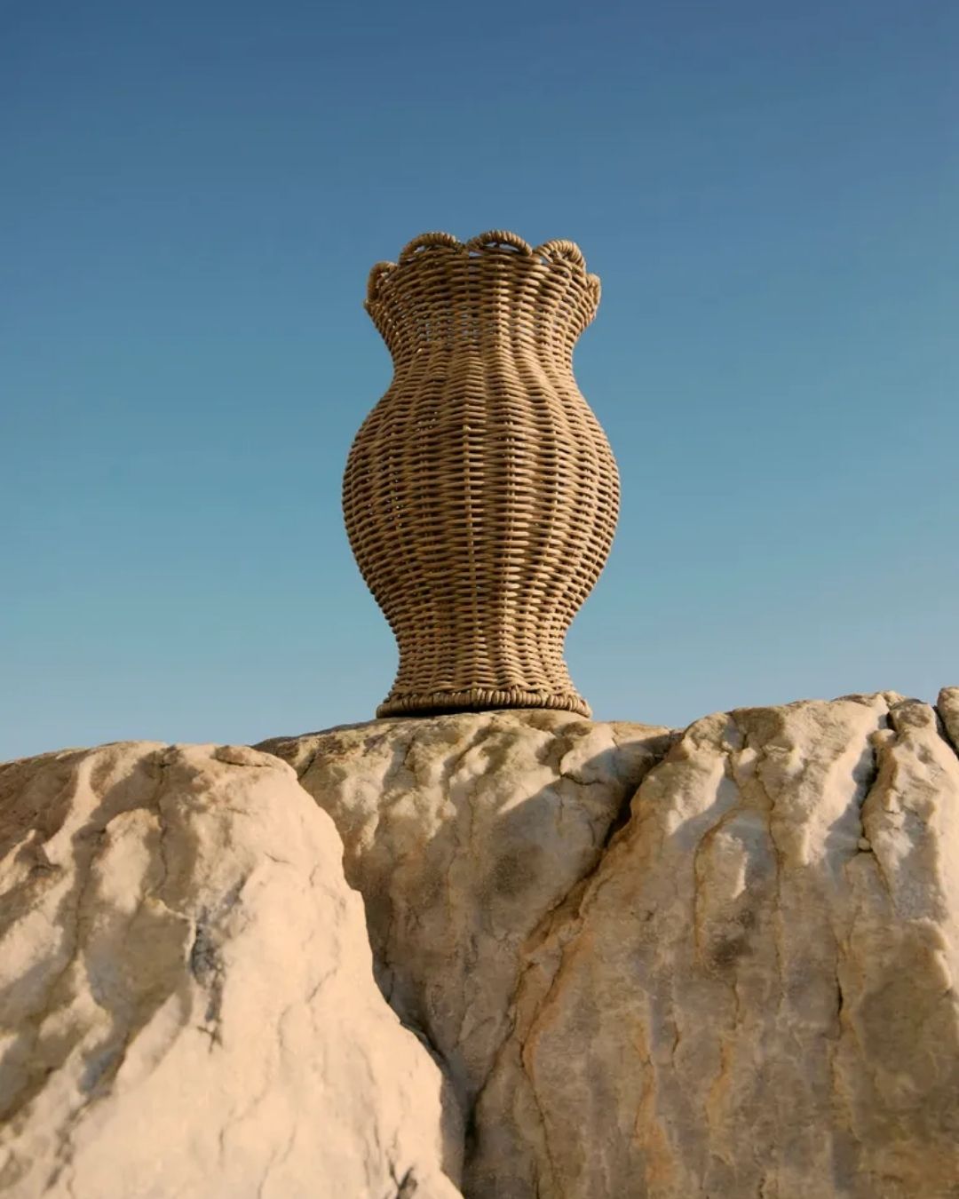 A series of sculptural rattan decorative items, including place mats, cake stands, laundry baskets, lights, napkin rings, and storage units.