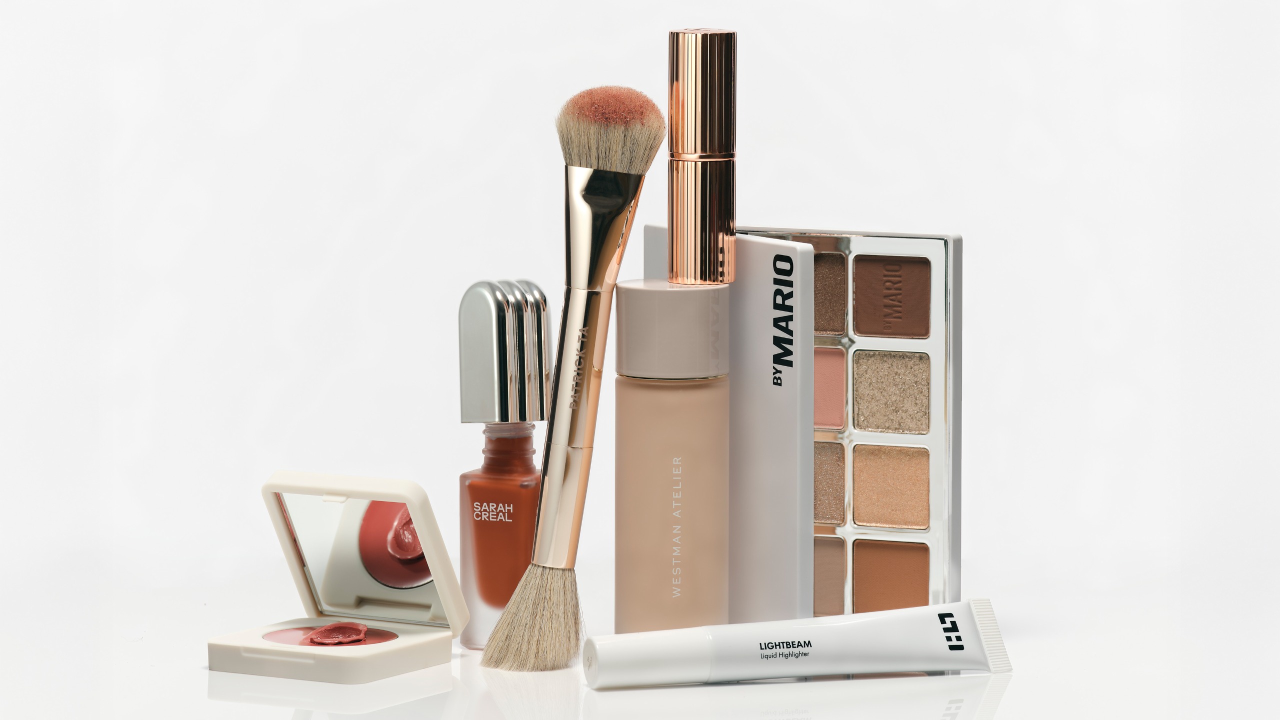 a selection of makeup products on a white background
