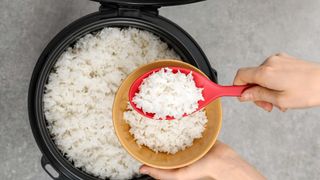 Dishing out white rice from a rice cooker