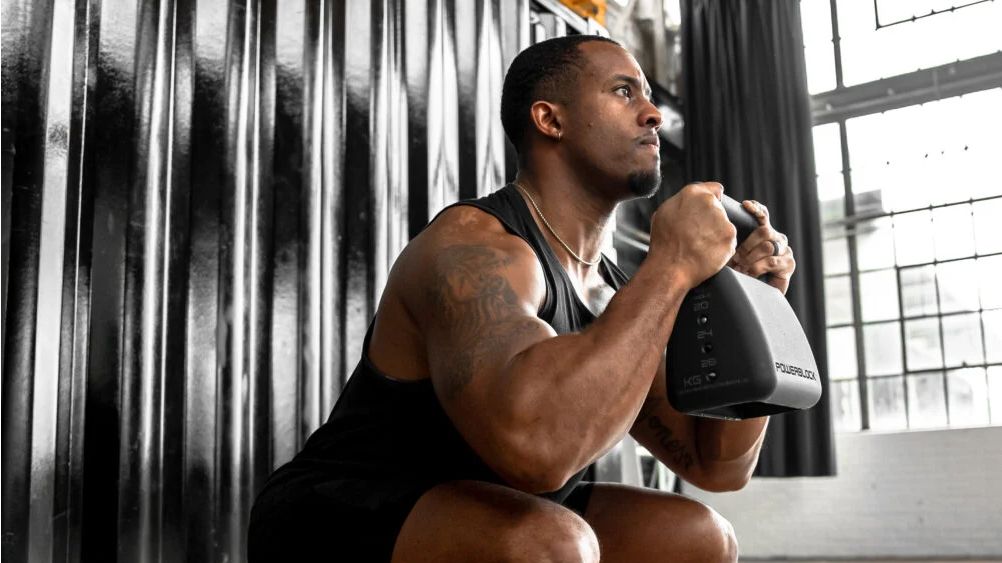 Man working out with the PowerBlock Adjustable Kettlebell