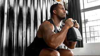 Man working out with the PowerBlock Adjustable Kettlebell