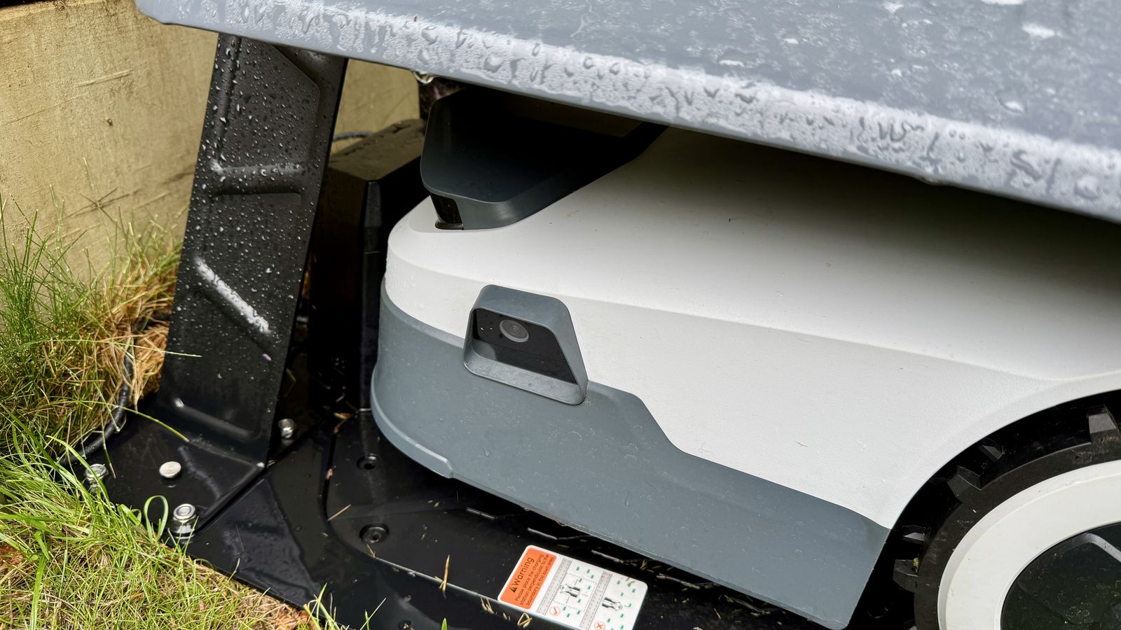 Anthbot Genie 300 robot lawn mower in its garage
