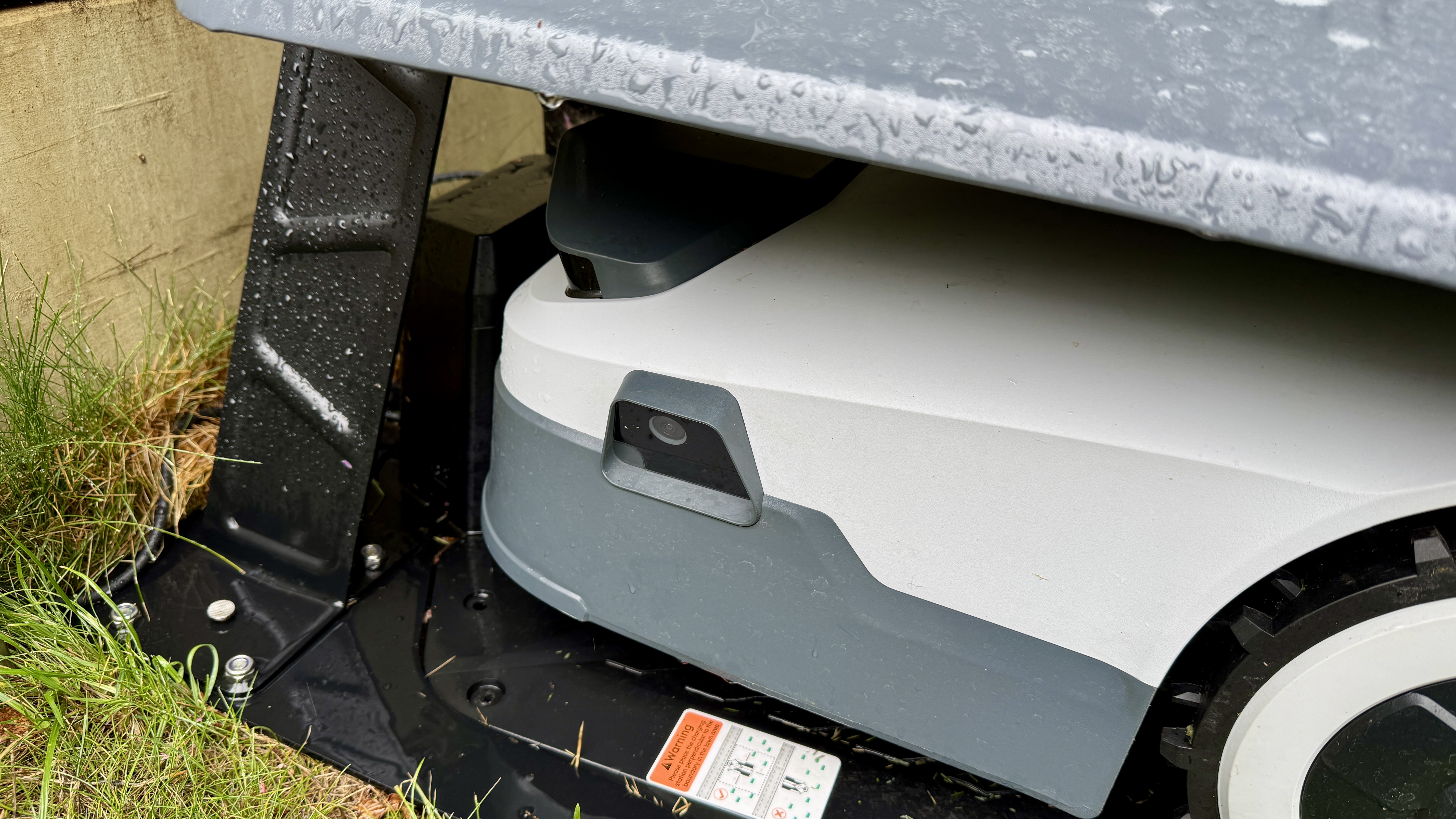 Anthbot Genie 300 robot lawn mower in its garage