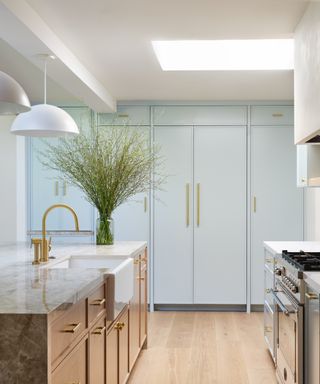best blue paint, pale blue kitchen cabinets, metallic fixtures and fittings, island, pendant lights