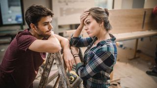Young couple having problems while renovating their apartment
