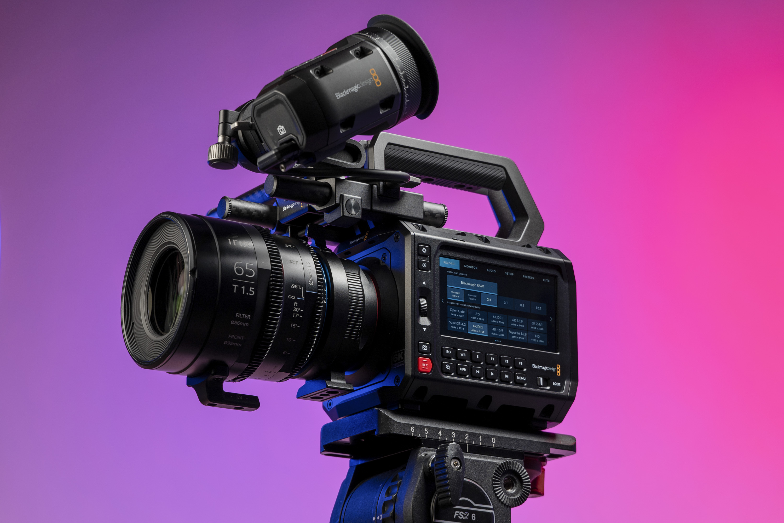 Blackmagic Pyxis 6K camera in the studio, mounted to video tripod, with a vibrant magenta background