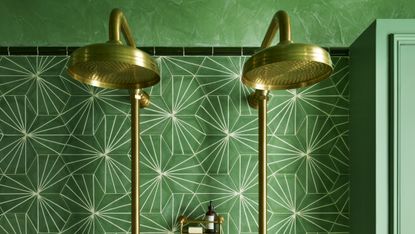 A mall bathroom shower with striking green tiles and double shower head
