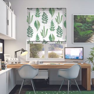 Angel Ferns Emerald Roller Blinds with foliage print in office with wooden table and ergonomic light blue desk chairs