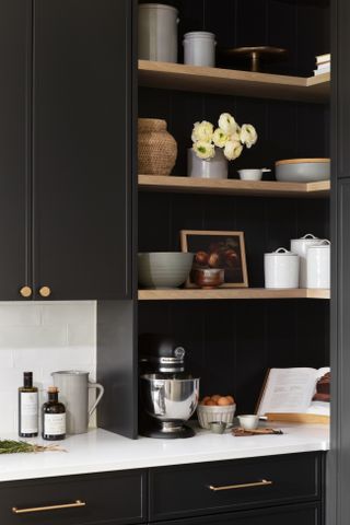 A kitchen with a dark palette