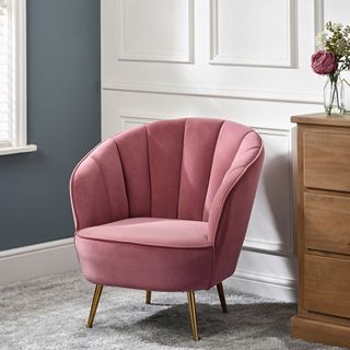 pink chair with rug and flower