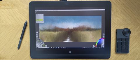 XPPen Artist Pro 16 (Gen 2) review; a drawing tablet on a wooden desk with accessories