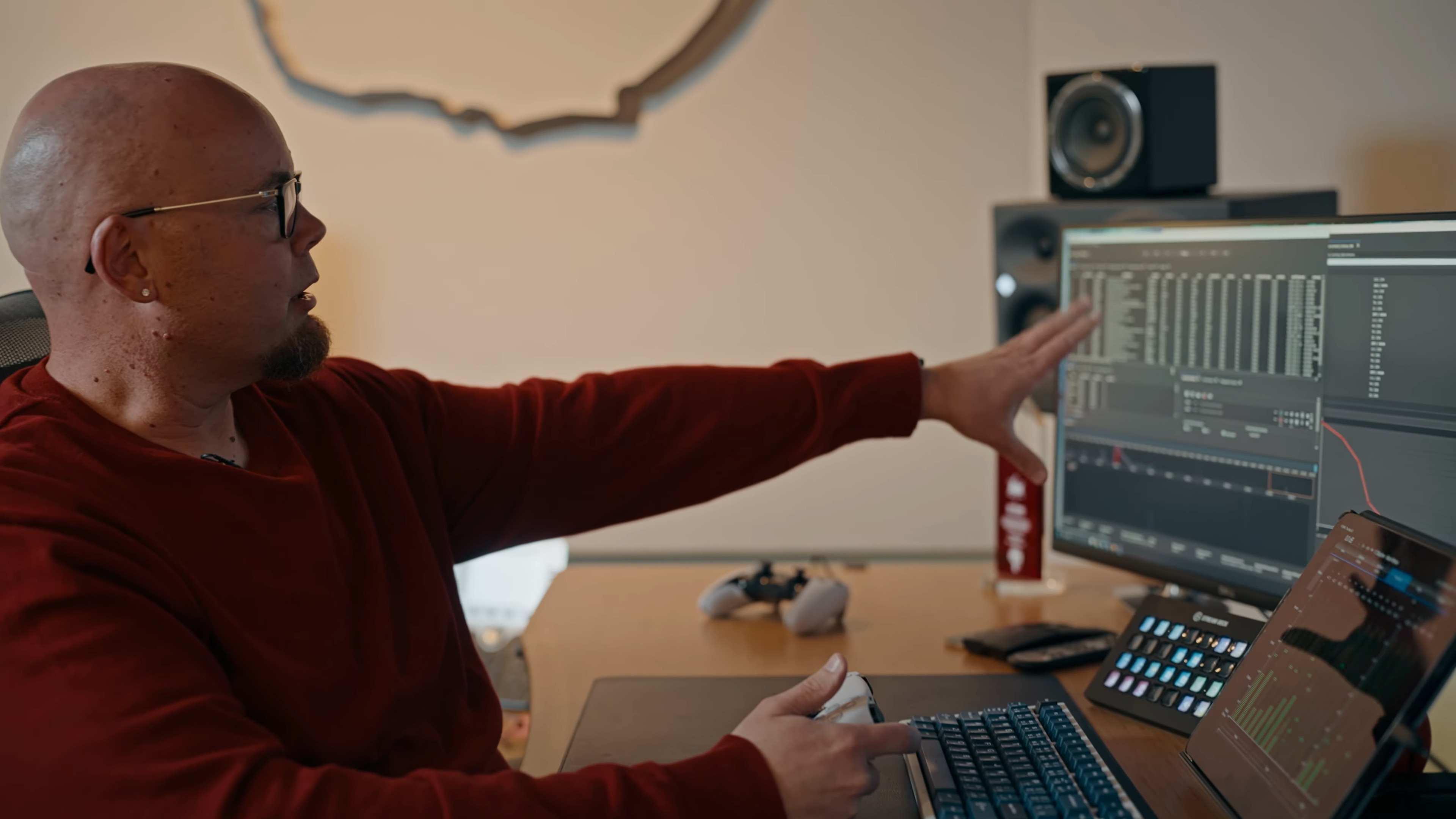 Infinity Ward studio audio director Stephen Miller sits at a desk with a computer. Audio mixing software is displayed on the screen, and Miller is discussing the audio tech behind Modern Warfare 4.
