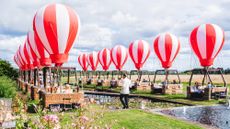 Waiter taking food to mini hot air balloons for dining experience Feast on Cloud 9, The Grove hotel